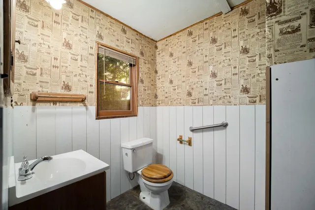 a bathroom with a sink toilet and a mirror
