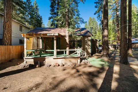 a view of a house with backyard porch and sitting area