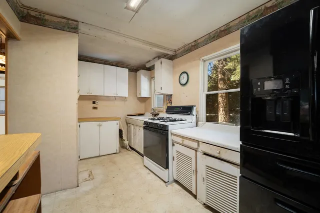 a kitchen that has a sink and a stove top oven