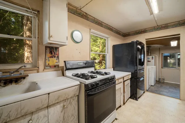 a kitchen with stainless steel appliances granite countertop a stove and a refrigerator