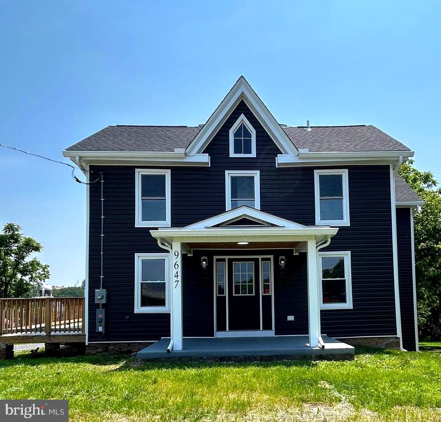 9647 Liberty Road Frederick, MD 21701 - Photo 1 of 14 a front view of a house with a yard