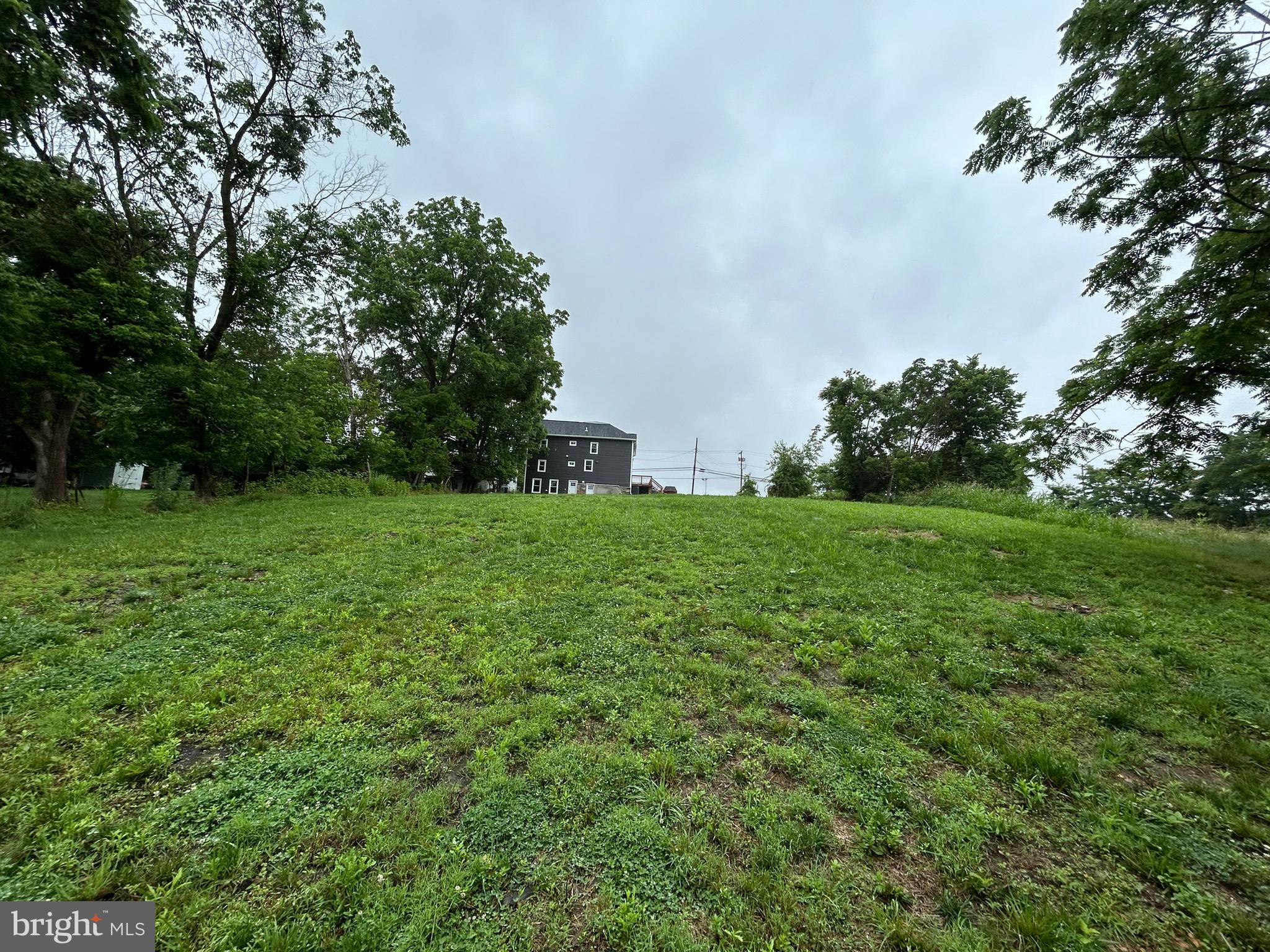 9647 Liberty Road Frederick, MD 21701 - Photo 14 of 14 a view of a grassy field with trees in the background