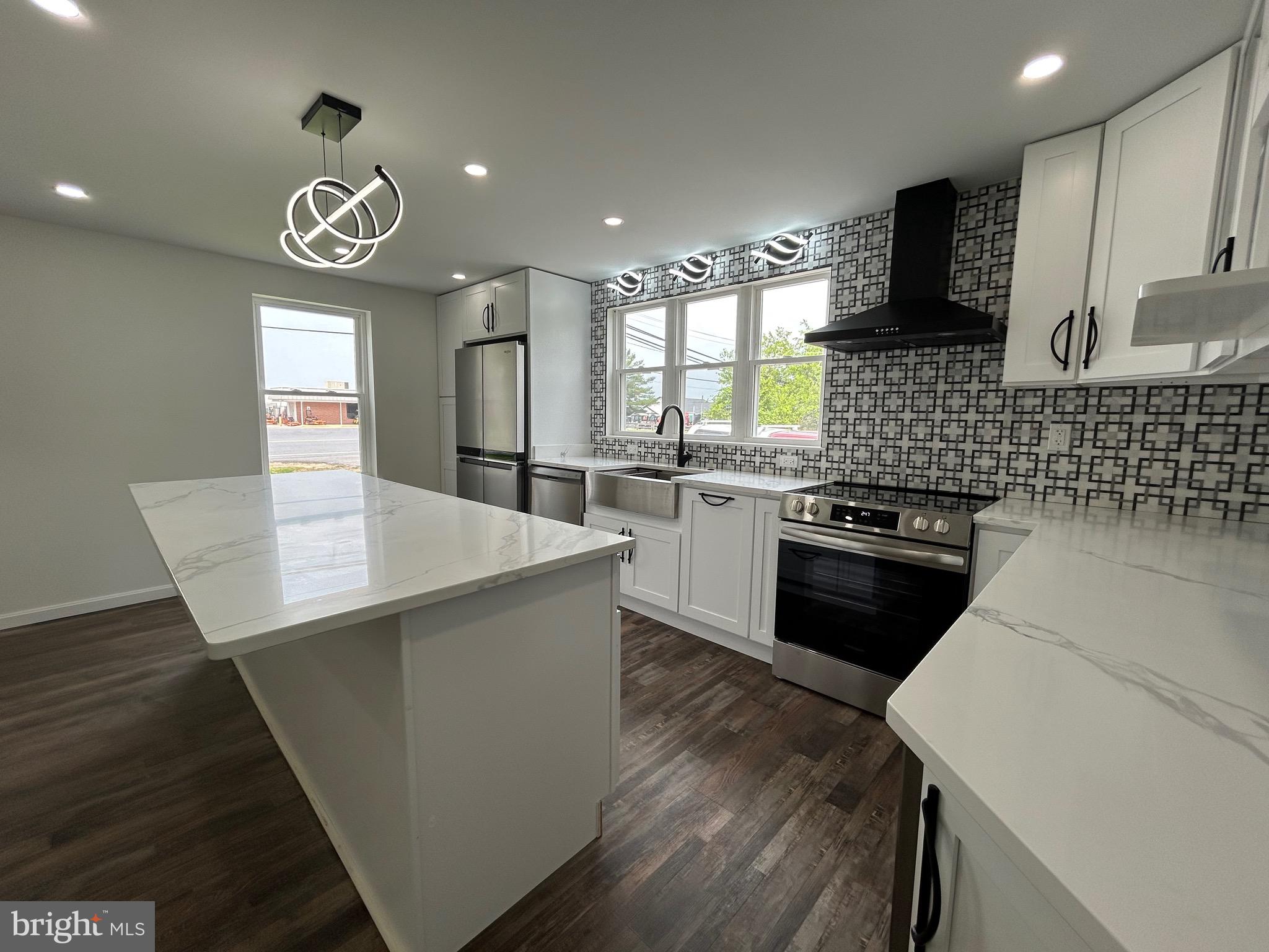 9647 Liberty Road Frederick, MD 21701 - Photo 5 of 14 a kitchen with stainless steel appliances granite countertop a sink a stove and a wooden floors