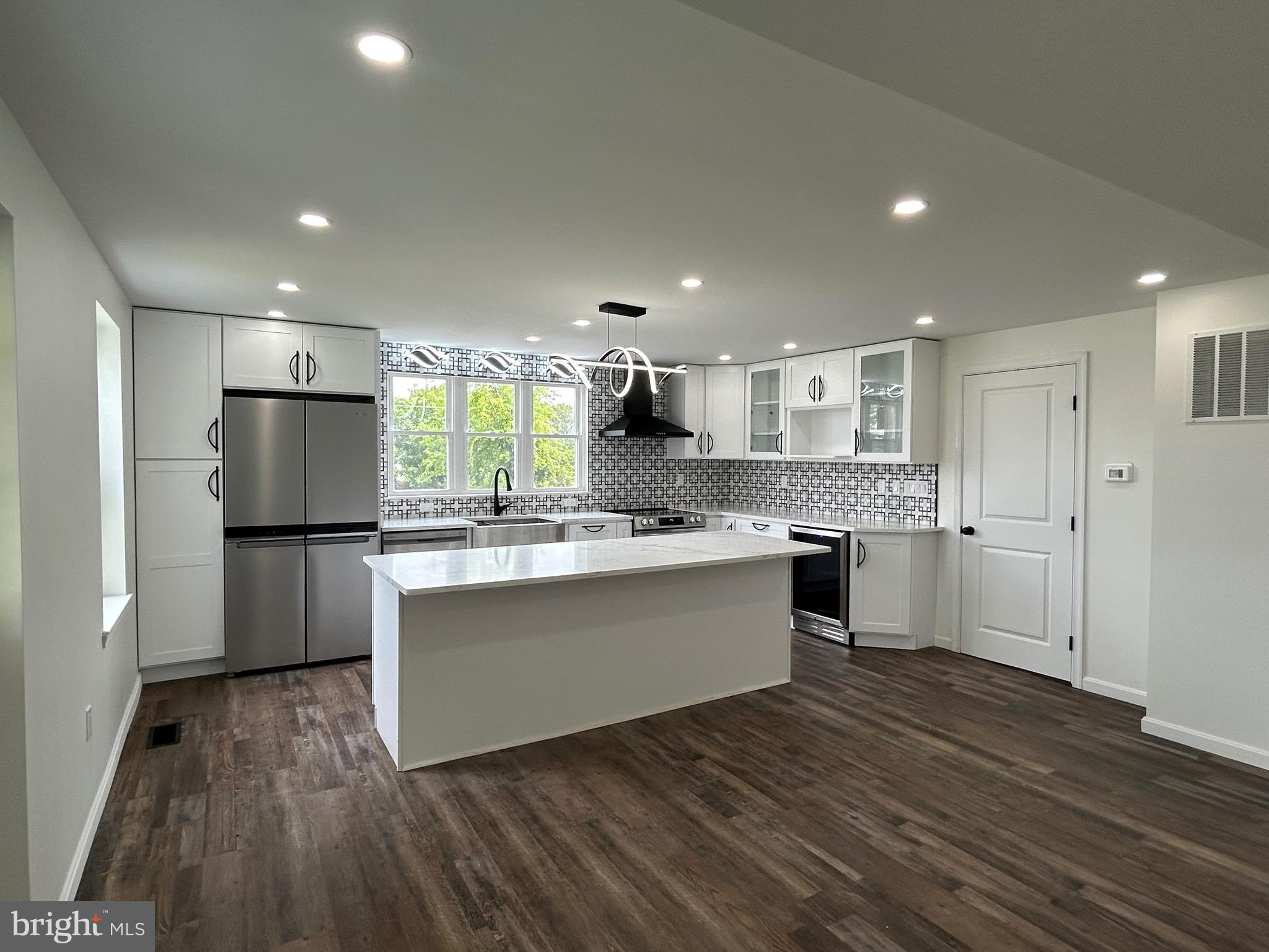 9647 Liberty Road Frederick, MD 21701 - Photo 6 of 14 a large kitchen with cabinets wooden floor and stainless steel appliances
