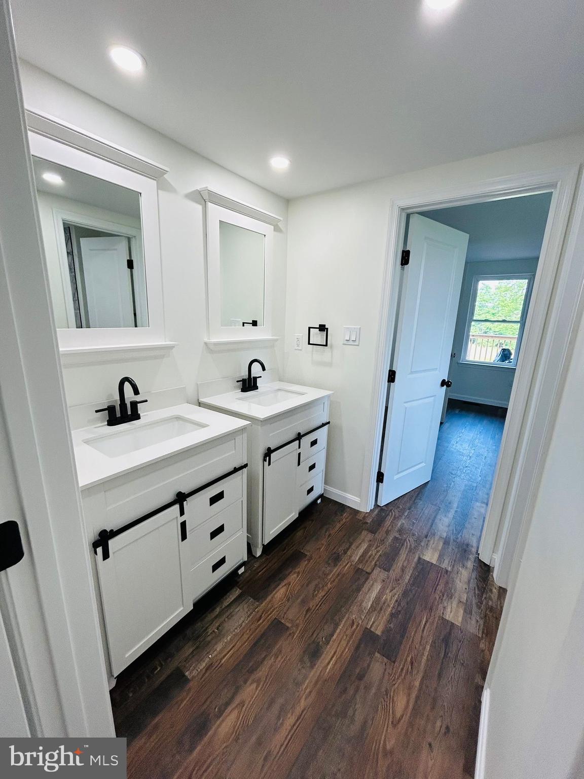 9647 Liberty Road Frederick, MD 21701 - Photo 8 of 14 a spacious bathroom with double vanity and a mirror