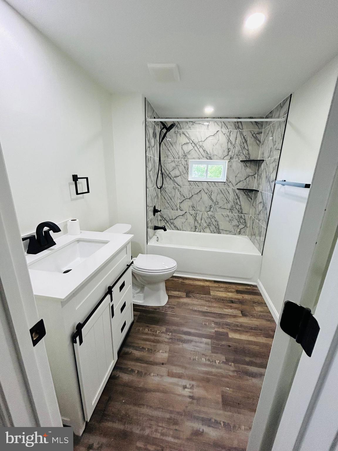 9647 Liberty Road Frederick, MD 21701 - Photo 10 of 14 a bathroom with a sink a toilet and shower