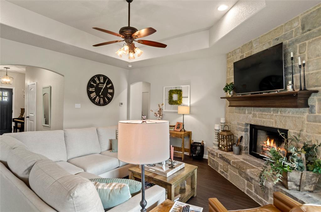 6093 Farm To Market Road 730 North Decatur, TX 76234 - Photo 4 of 28 a living room with furniture a flat screen tv and a fireplace