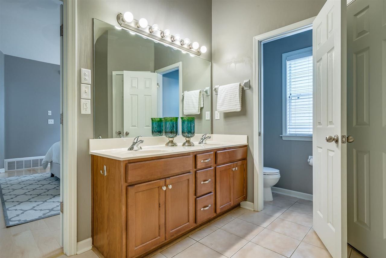 1448 Island Town Cove Memphis, TN 38103 - Photo 9 of 18 a bathroom with a double vanity sink and a mirror