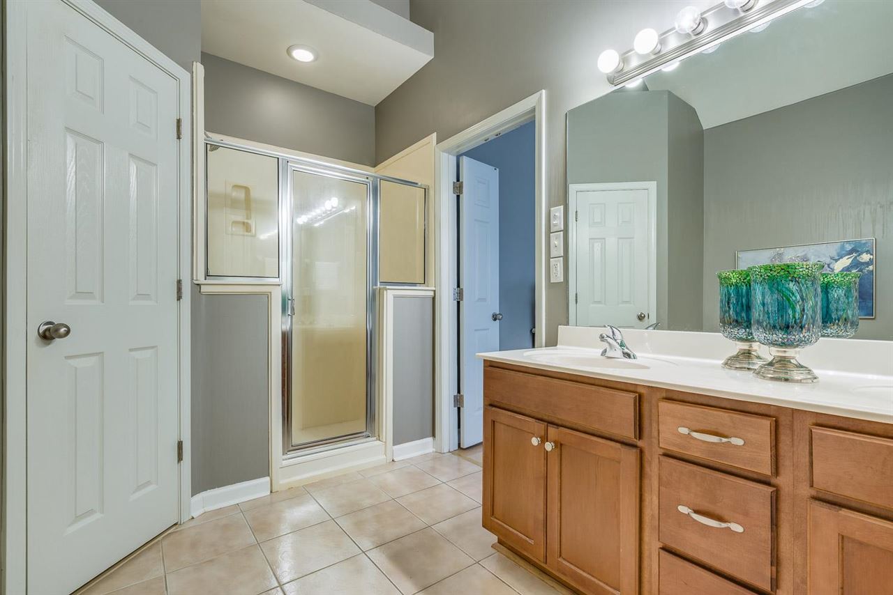 1448 Island Town Cove Memphis, TN 38103 - Photo 10 of 18 a bathroom with a double vanity sink mirror and shower