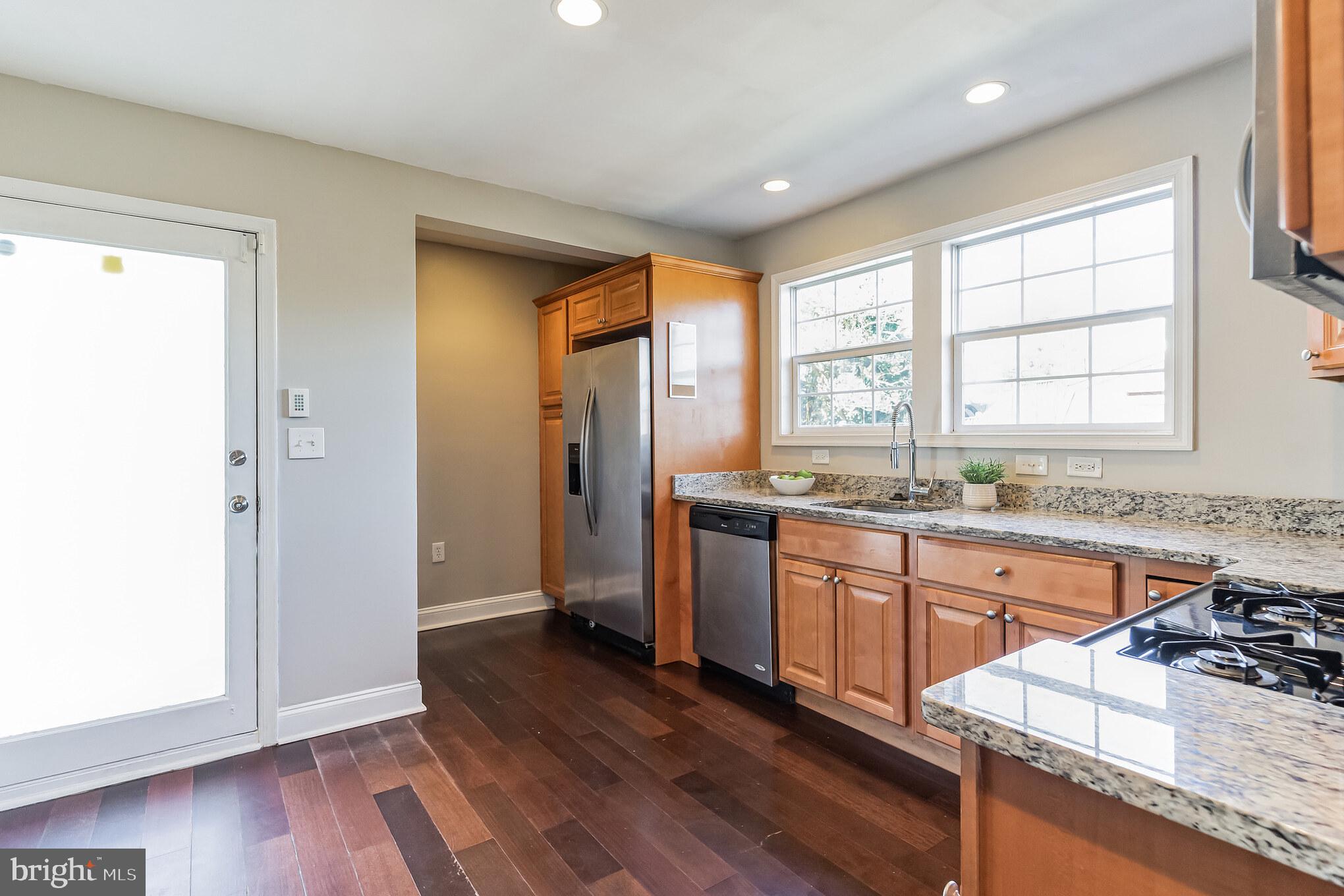 2810 Manoff Road Halethorpe, MD 21227 - Photo 4 of 27 a kitchen with stainless steel appliances granite countertop wooden floors and sink