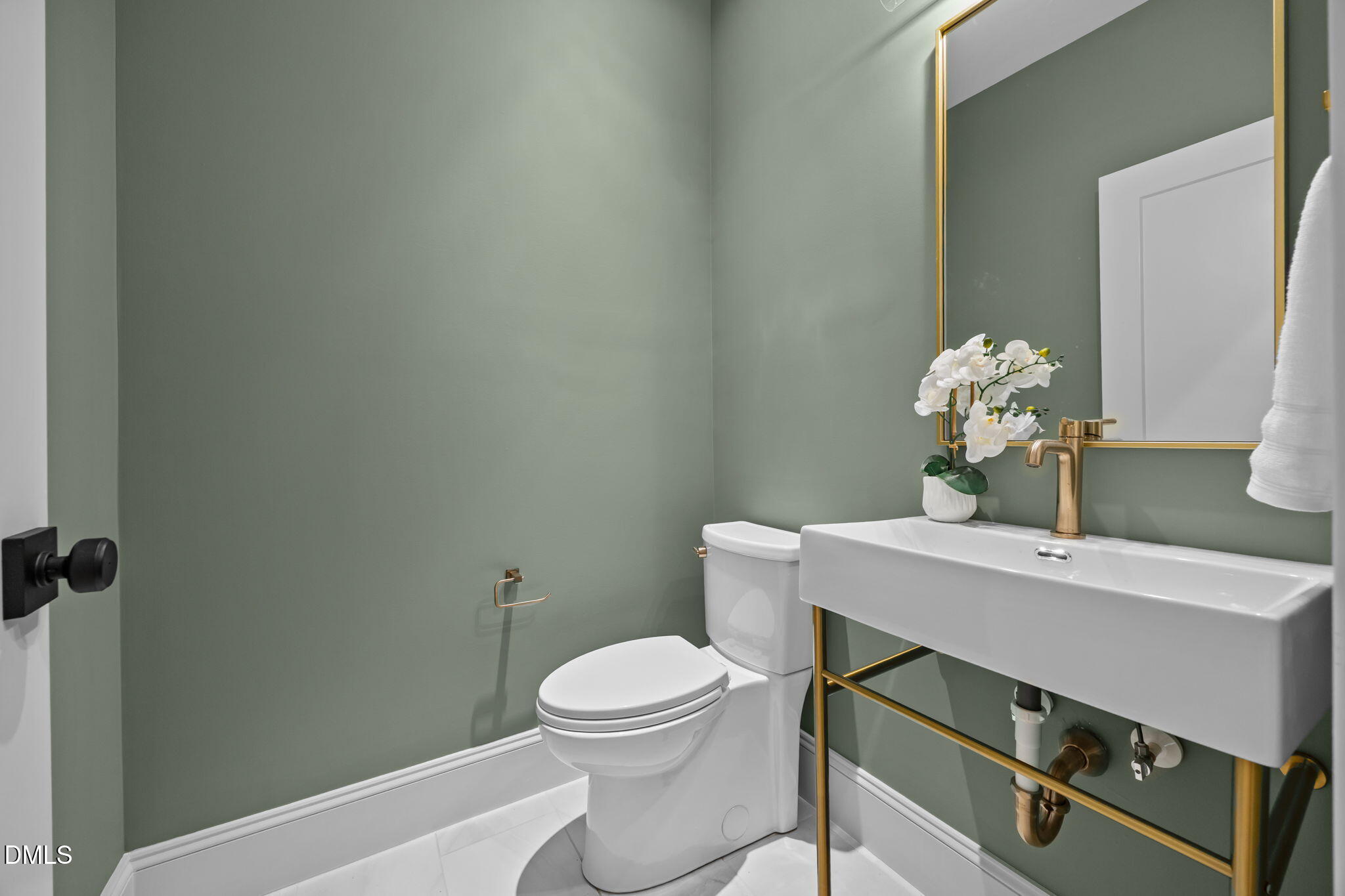 805 Tower Street, Unit 101 Raleigh, NC 27607 - Photo 11 of 38 a bathroom with a toilet a sink and mirror