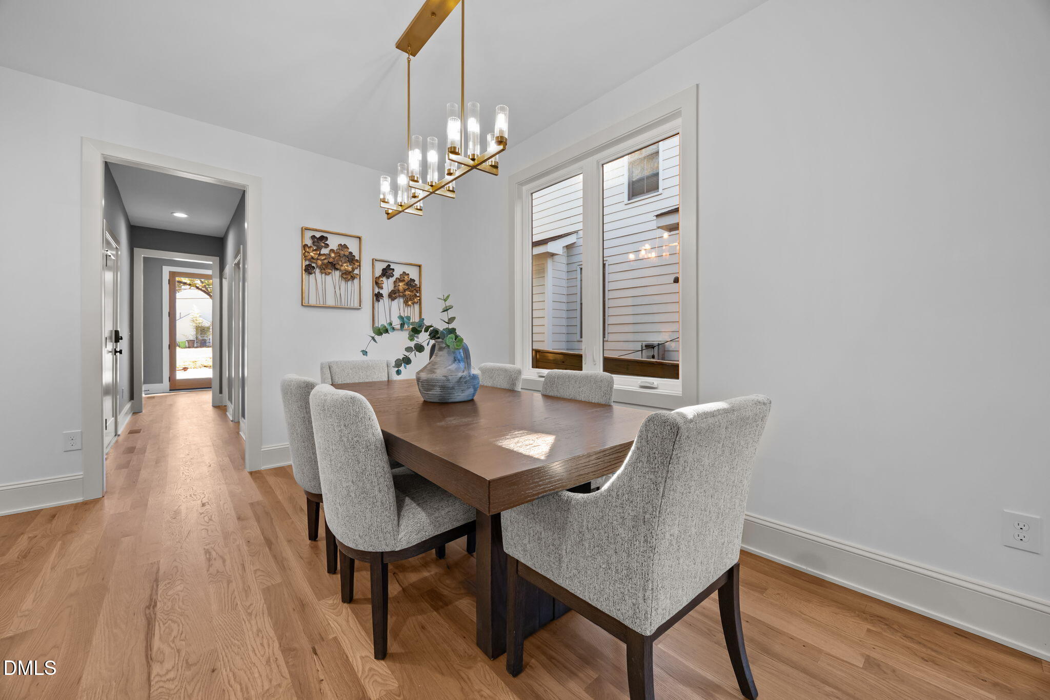 805 Tower Street, Unit 101 Raleigh, NC 27607 - Photo 13 of 38 a view of a dining room with furniture a chandelier and wooden floor
