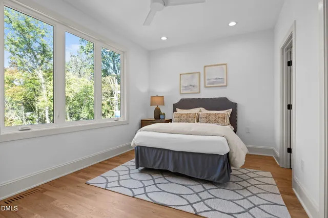a bedroom with a large bed and a window