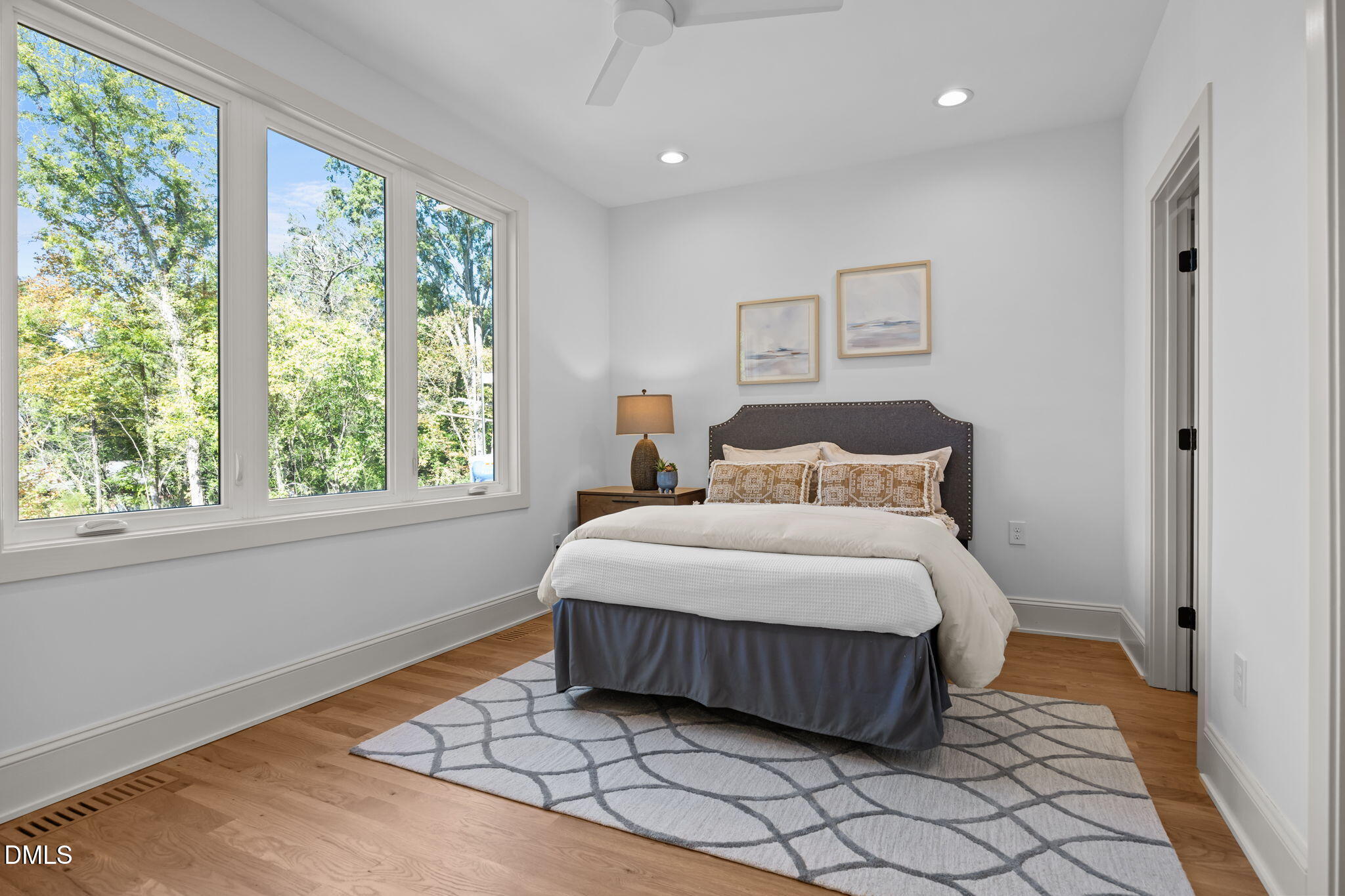 805 Tower Street, Unit 101 Raleigh, NC 27607 - Photo 15 of 38 a bedroom with a bed and a large window