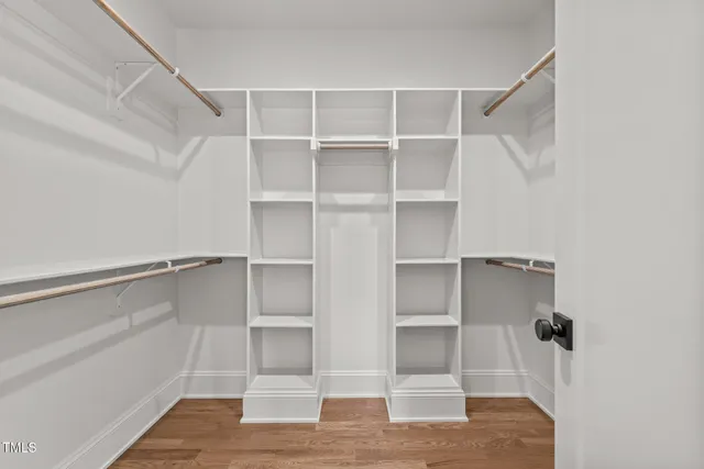 a view of walk in closet with empty racks