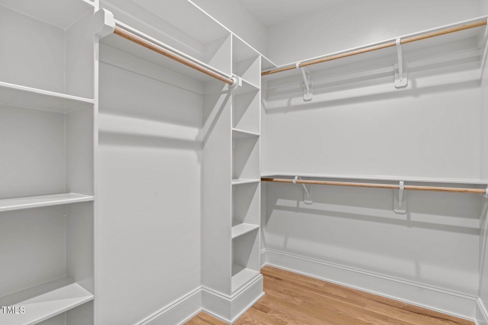 805 Tower Street, Unit 101 Raleigh, NC 27607 - Photo 22 of 38 a view of walk in closet with empty racks