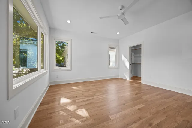 a bathroom with a granite countertop sink toilet a large mirror and shower