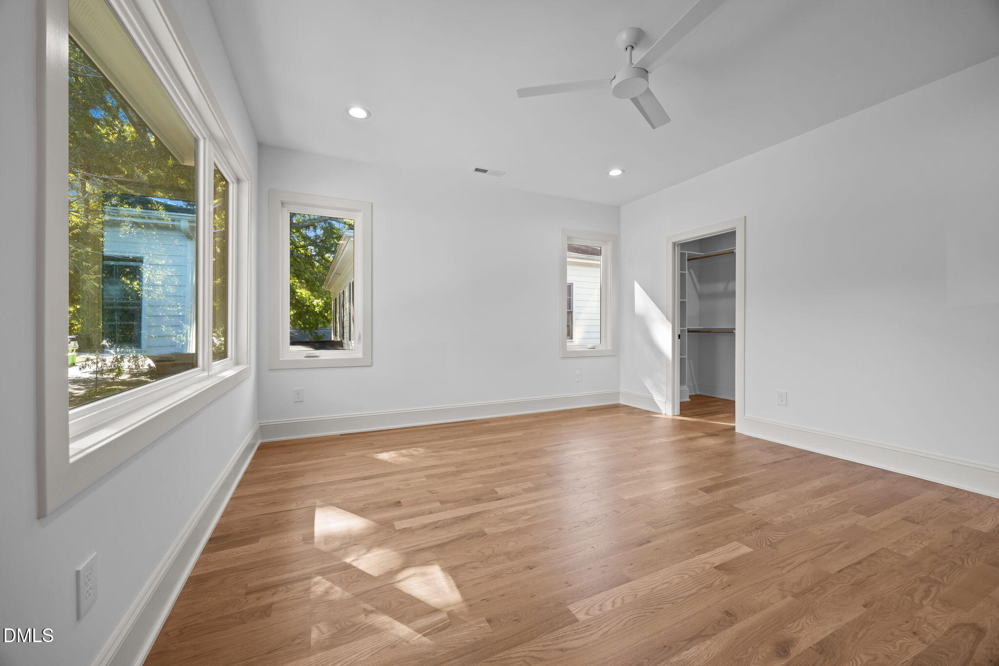 805 Tower Street, Unit 101 Raleigh, NC 27607 - Photo 25 of 38 a view of an empty room with a window and wooden floor