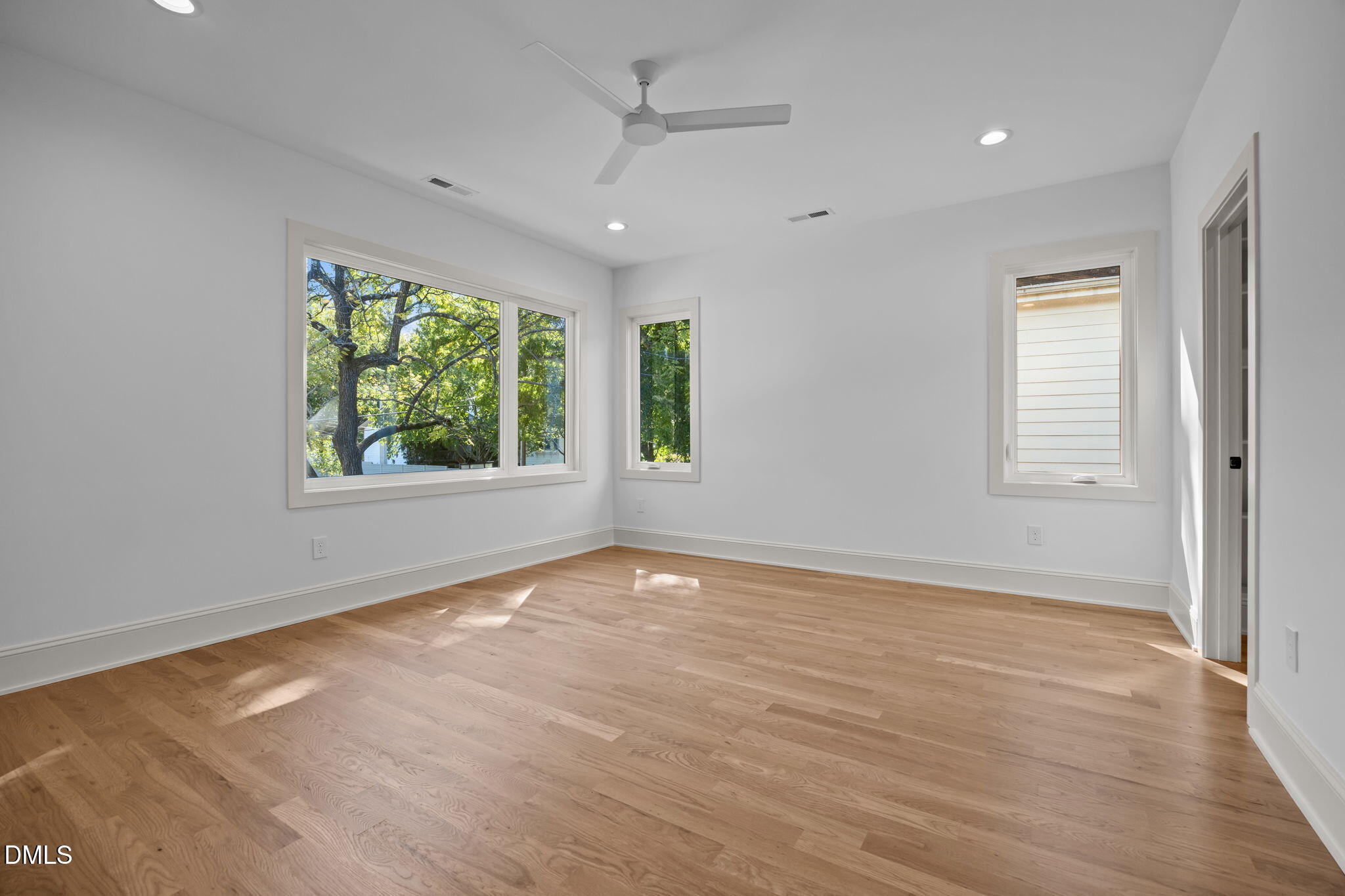 805 Tower Street, Unit 101 Raleigh, NC 27607 - Photo 26 of 38 an empty room with wooden floor and windows
