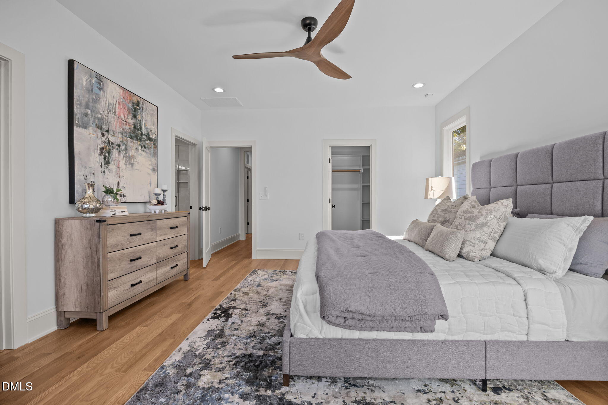 805 Tower Street, Unit 101 Raleigh, NC 27607 - Photo 29 of 38 a bedroom with a bed and a mirror
