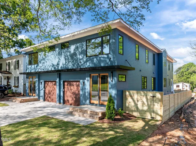 a kitchen with kitchen island granite countertop a sink cabinets and stainless steel appliances