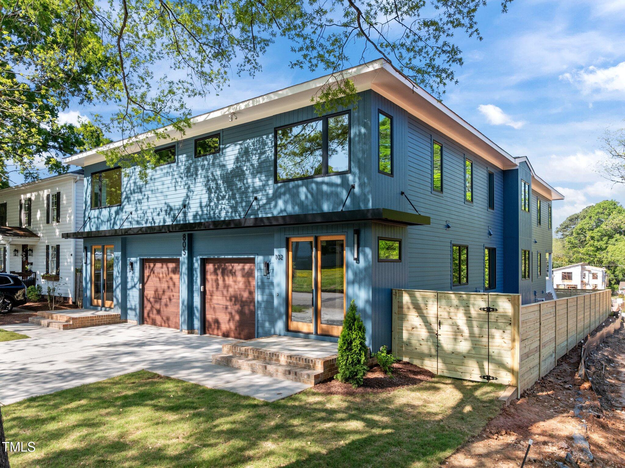 805 Tower Street, Unit 101 Raleigh, NC 27607 - Photo 5 of 38 a front view of a house with a yard