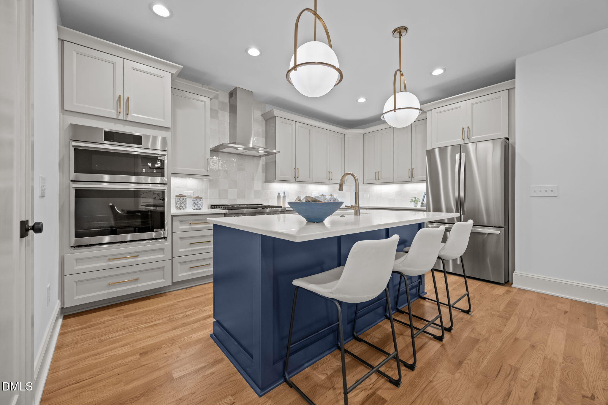 805 Tower Street, Unit 101 Raleigh, NC 27607 - Photo 6 of 38 a kitchen with kitchen island granite countertop a sink cabinets and stainless steel appliances