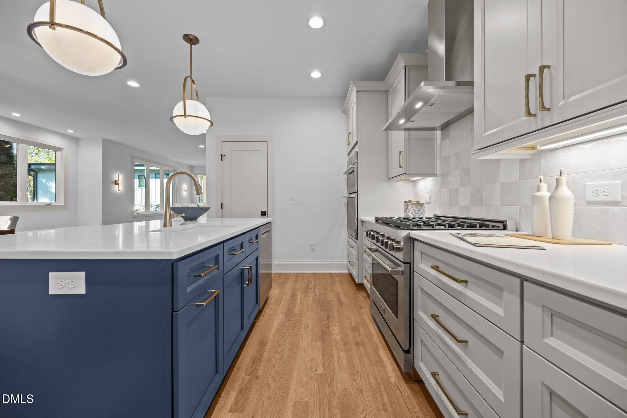 805 Tower Street, Unit 101 Raleigh, NC 27607 - Photo 7 of 38 a large kitchen with granite countertop a large center island a sink stainless steel appliances and cabinets