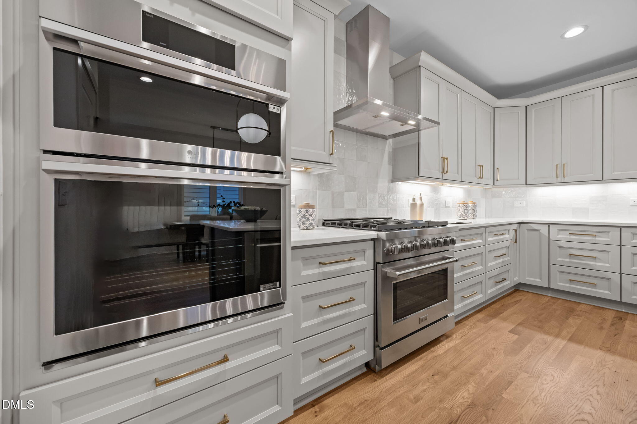 805 Tower Street, Unit 101 Raleigh, NC 27607 - Photo 8 of 38 a kitchen with stainless steel appliances granite countertop a stove and a microwave
