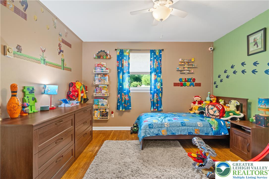 50 Kohls Road Northampton, PA 18067 - Photo 20 of 54 A cheerful children's bedroom featuring wood flooring and a window offering natural light.