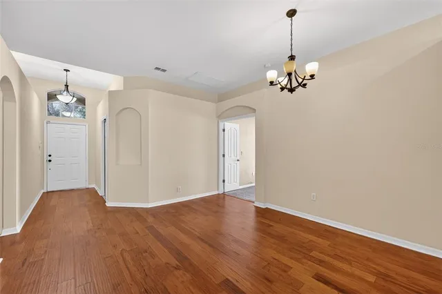 a view of a chandelier fan and wooden floor