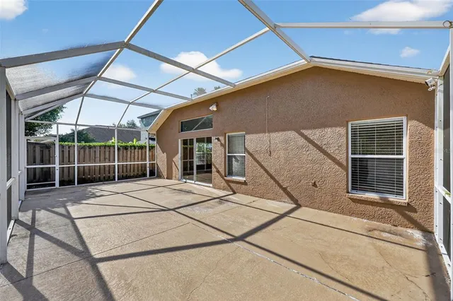 a backyard of a house with sofas