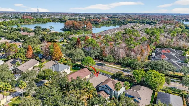 an aerial view of house with yard and ocean view
