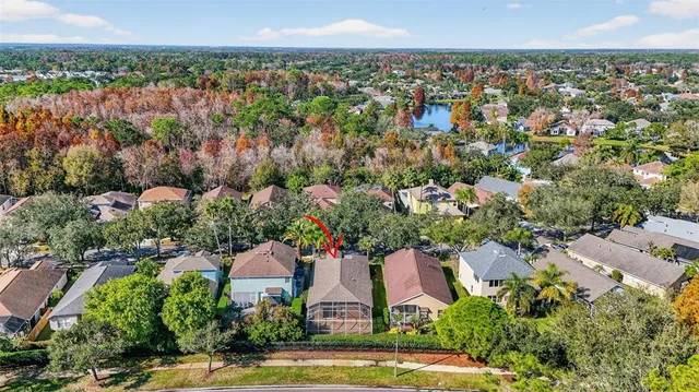 an aerial view of a house with a yard and lake view