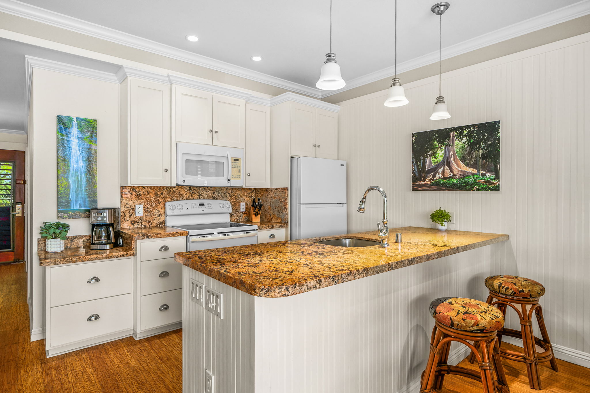 2253 Poipu Road, Unit 26 Koloa, HI 96756 - Photo 7 of 21 a kitchen that has a cabinets and chairs in it