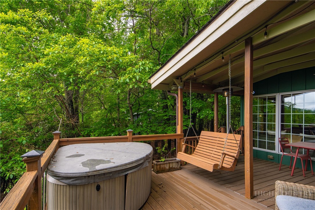 280 Chinkapin Ridge Road Seven Devils, NC 28604 - Photo 26 of 40 a view of a patio with table and chairs with wooden floor and fence