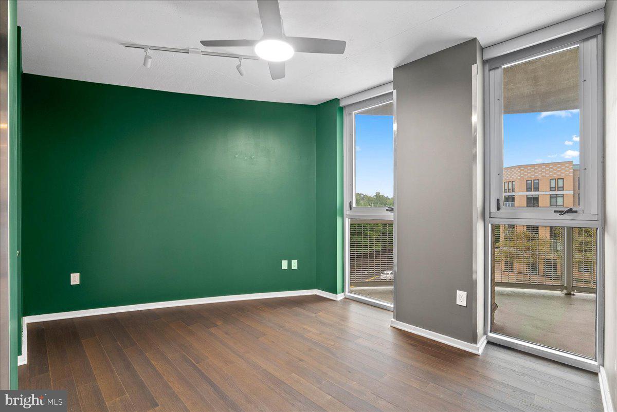 3409 Wilson Boulevard, Unit 412 Arlington, VA 22201 - Photo 14 of 19 an empty room with wooden floor and windows