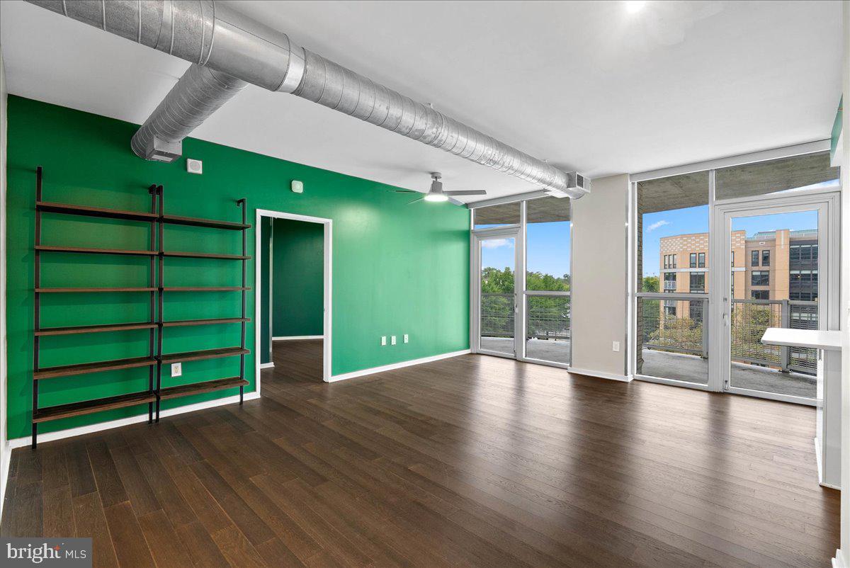 3409 Wilson Boulevard, Unit 412 Arlington, VA 22201 - Photo 7 of 19 an empty room with wooden floor windows and entryway