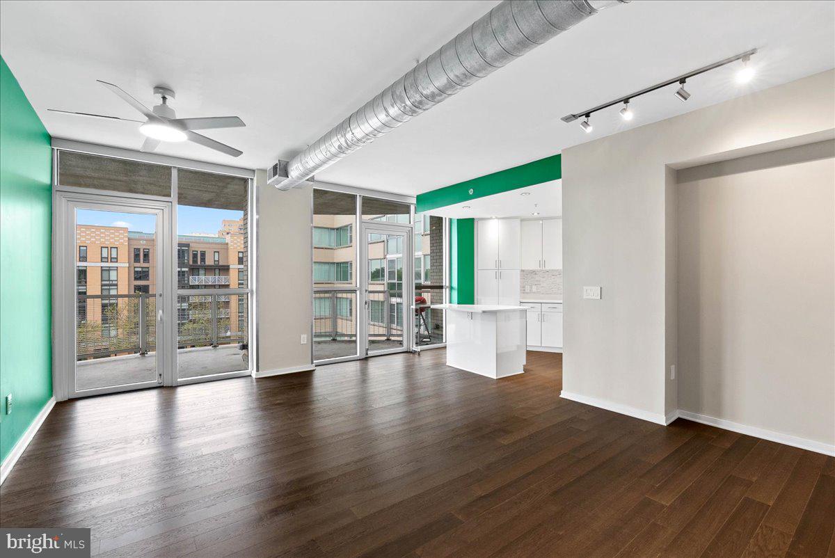 3409 Wilson Boulevard, Unit 412 Arlington, VA 22201 - Photo 8 of 19 a view of an empty room with wooden floor and a window