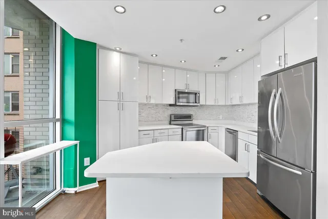 a kitchen with refrigerator and cabinets