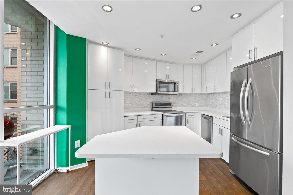 3409 Wilson Boulevard, Unit 412 Arlington, VA 22201 - Photo 10 of 19 a kitchen with refrigerator and cabinets