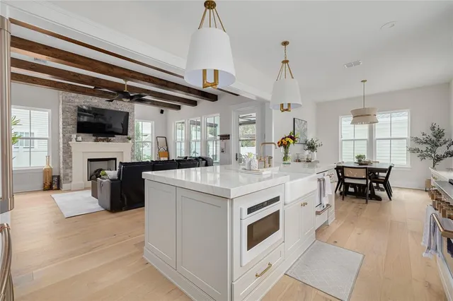 a kitchen with a stove and a chandelier