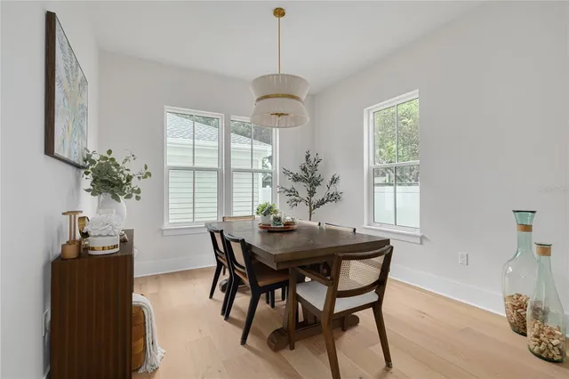 a dining room with furniture window and wooden floor