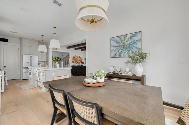 a kitchen with stainless steel appliances granite countertop a table and a chair