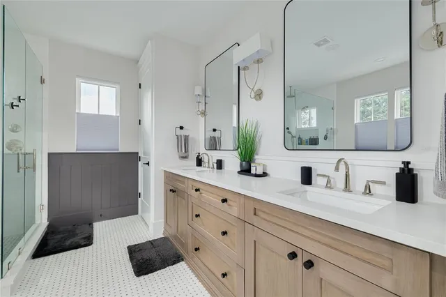 a bathroom with a double vanity sink and a mirror