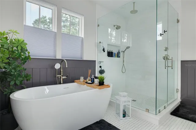 a white bath tub sitting next to a white toilet