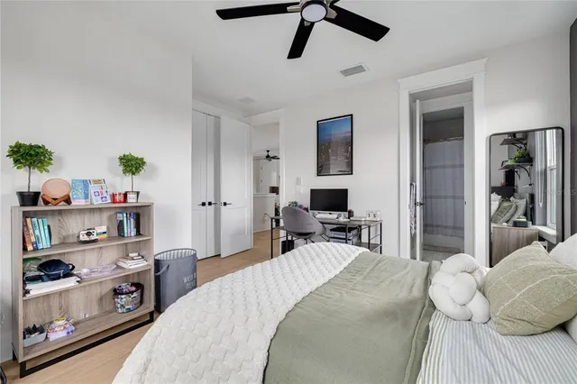 a bedroom with a bed and a tv