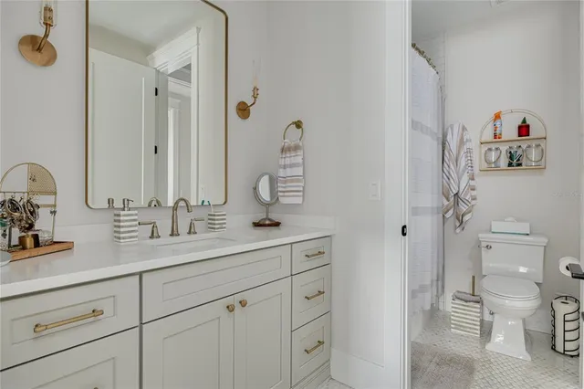 a bathroom with a sink a toilet and a mirror