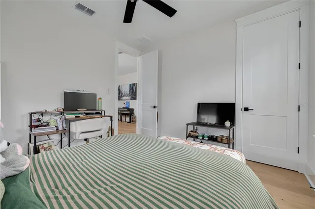 a bedroom with a bed and a flat screen tv