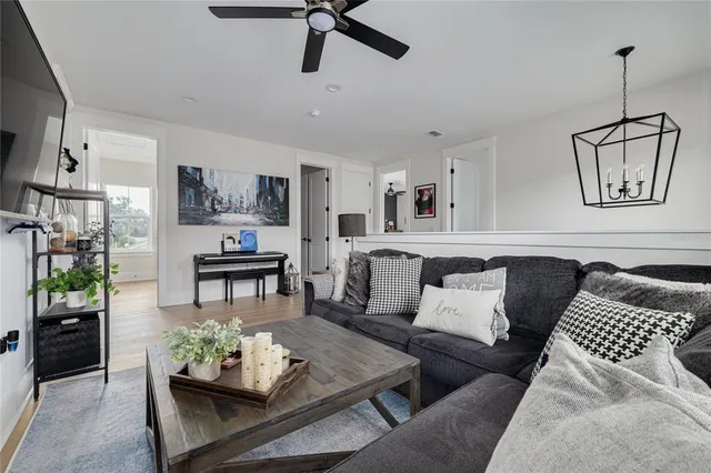 a living room with furniture and wooden floor